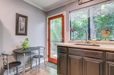 a kitchen with a sink and a table and a window at Downtown Fair Oaks Home about 15 Mi to Sacramento! in Fair Oaks