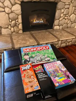 three games on a table in front of a fireplace at Walk-to-Lifts Condo with Hot Tub, Dog Friendly in Mammoth Lakes