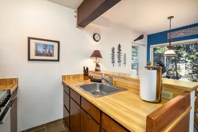 a kitchen with a sink and a counter at Cozy Corner Tamarack Condo 19 in Tamarack