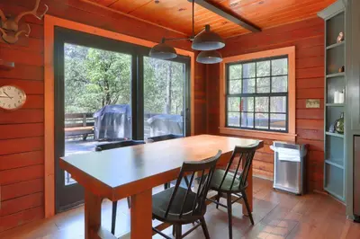 a dining room with a wooden table and chairs at 45 The Overlook in Wawona
