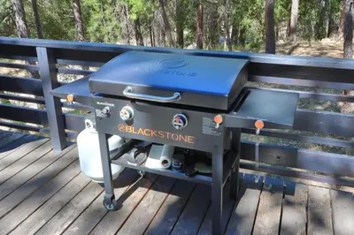 a grill sitting on a bench on a deck at 45 The Overlook in Wawona
