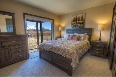 a bedroom with a bed and a window with a view at Epiphany home in South Lake Tahoe
