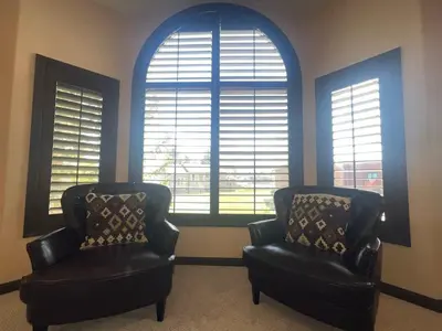 two chairs in a living room with two large windows at Epiphany home in South Lake Tahoe