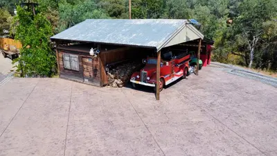 a small cabin with a red truck parked next to it at Enchanted Property near Yosemite, View, Game Room in Ahwahnee