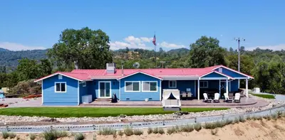 a blue house with a red roof at Enchanted Property near Yosemite, View, Game Room in Ahwahnee