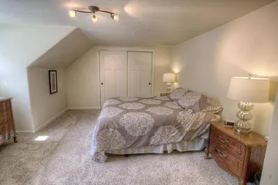 a bedroom with a bed and a dresser with a lamp at Corner Pocket Chalet home in South Lake Tahoe