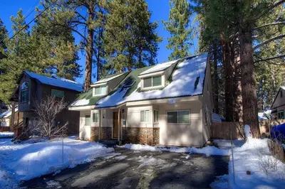 a house is covered in snow in a yard at Corner Pocket Chalet home in South Lake Tahoe