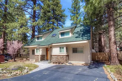 a house with a green roof and a driveway at Corner Pocket Chalet home in South Lake Tahoe