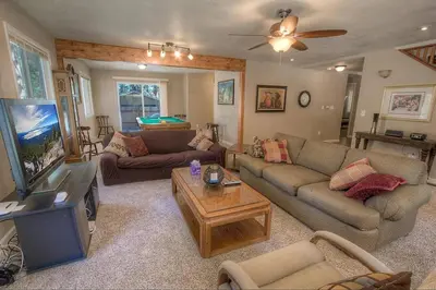 a living room with couches and a flat screen tv at Corner Pocket Chalet home in South Lake Tahoe