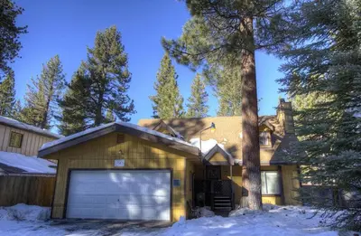 a house with a garage in the snow at Bambi's Bunkhouse home in South Lake Tahoe