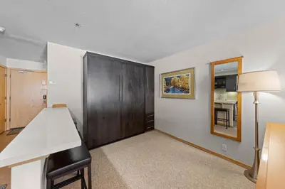 a room with a desk and a table and a mirror at Palisades Tahoe Lodge Rentals Studio Loft #356 in Olympic Valley