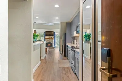 a kitchen with a long hallway with wooden flooring at Palisades Tahoe Lodge Rentals Premium Studio Loft #336 in Olympic Valley