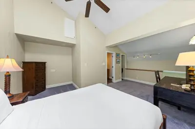 a bedroom with a large white bed and a desk at Palisades Tahoe Lodge Rentals Premium Studio Loft #336 in Olympic Valley