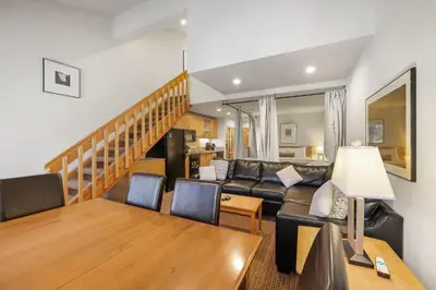 a living room with a couch and a table at Palisades Tahoe Lodge Rentals Studio Loft #346 in Olympic Valley