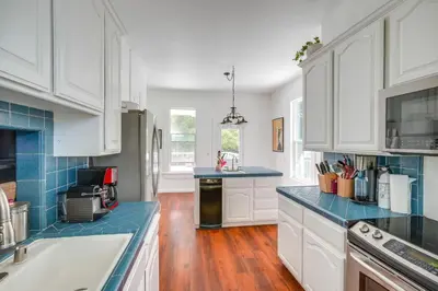 a kitchen with white cabinets and blue counter tops at Modesto Mansion on 2 Acres - Great for Families! in Modesto