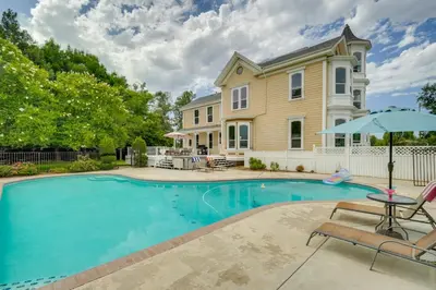 a swimming pool in front of a house at Modesto Mansion on 2 Acres - Great for Families! in Modesto