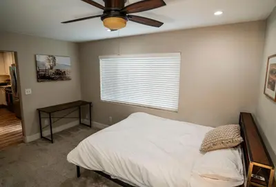 a bedroom with a bed and a ceiling fan at Truckee River Ranch in Reno