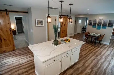 a kitchen with a white island in a room at Truckee River Ranch in Reno