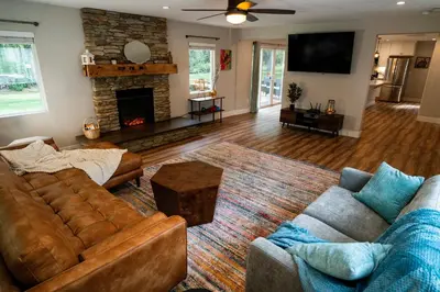 a living room with two couches and a fireplace at Truckee River Ranch in Reno