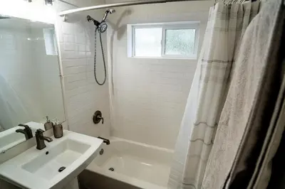 a white bathroom with a sink and a shower at Truckee River Ranch in Reno