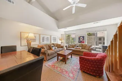 a living room with a couch and a table at Palisades Tahoe Lodge Rentals Studio Loft #338 in Olympic Valley