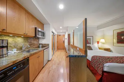 a hotel room with a bed and a kitchen at Palisades Tahoe Lodge Rentals Studio Loft #338 in Olympic Valley