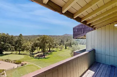 an outdoor balcony with a view of a golf course at Above the Green in Groveland