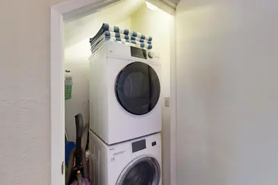 a microwave and a washer and dryer in a room at Above the Green in Groveland