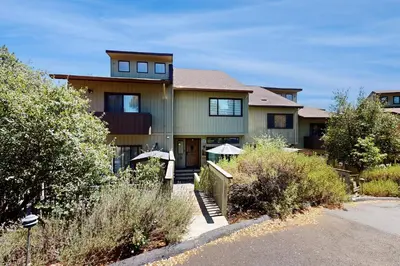 a large house with a yard with bushes at Above the Green in Groveland