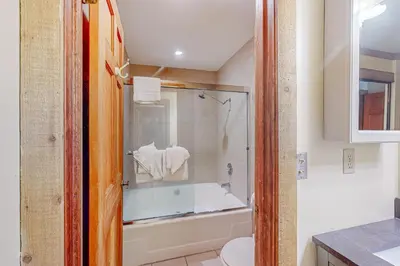a bathroom with a shower and a tub and a toilet at Mountainback 35 in Mammoth Lakes