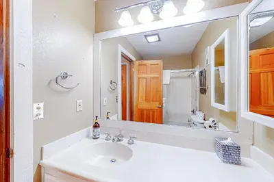 a bathroom with a sink and a large mirror at Mountainback 35 in Mammoth Lakes
