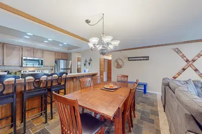 a kitchen and living room with a wooden table and chairs at Mountainback 35 in Mammoth Lakes