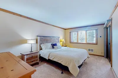 a bedroom with a bed and a desk and a window at Mountainback 35 in Mammoth Lakes