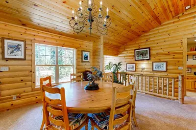 a dining room with a wooden table and chairs at Spacious Deck with Private Hot Tub Kings Beach Gem in Wood Vista