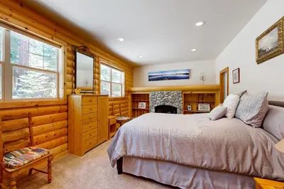 a bedroom with a bed and a fireplace at Spacious Deck with Private Hot Tub Kings Beach Gem in Wood Vista