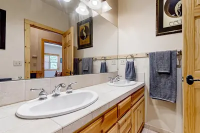 a bathroom with two sinks and a large mirror at Spacious Deck with Private Hot Tub Kings Beach Gem in Wood Vista