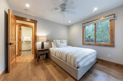 a bedroom with a bed and a ceiling fan at Eclipse Retreat at Tahoe Park - Hot Tub - Fenced Yard & steps to HOA Access in Tahoe City
