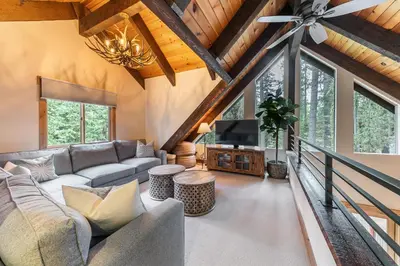 a living room with a couch and a tv at Eclipse Retreat at Tahoe Park - Hot Tub - Fenced Yard & steps to HOA Access in Tahoe City