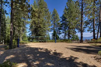 a park with a volleyball net and trees at Eclipse Retreat at Tahoe Park - Hot Tub - Fenced Yard & steps to HOA Access in Tahoe City