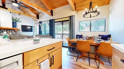 a kitchen and dining room with a table and chairs at Bigwood #45 condo in Mammoth Lakes