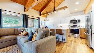 a living room with a couch and a kitchen at Bigwood #45 condo in Mammoth Lakes