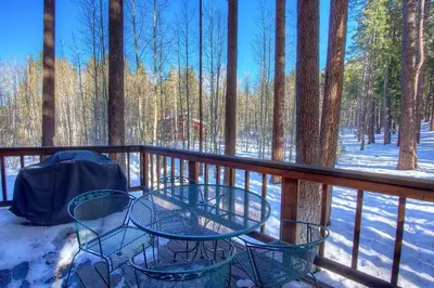 a balcony with two chairs and a table in the snow at Aspen View Lodge home in South Lake Tahoe