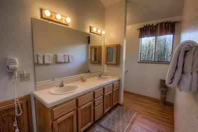 a bathroom with two sinks and a large mirror at Aspen View Lodge home in South Lake Tahoe