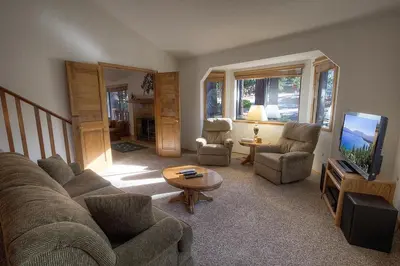 a living room with a couch and chairs and a tv at Aspen View Lodge home in South Lake Tahoe