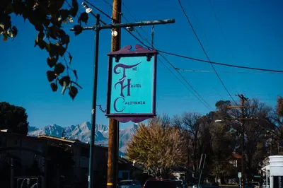 a sign hanging from a pole on a street at The Hostel California in Bishop