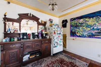 a kitchen with a refrigerator and a painting on the wall at The Hostel California in Bishop
