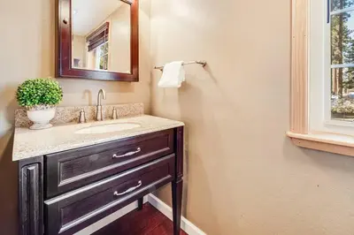 a bathroom with a sink and a mirror at Alpine Cottage Hideaway in Stateline