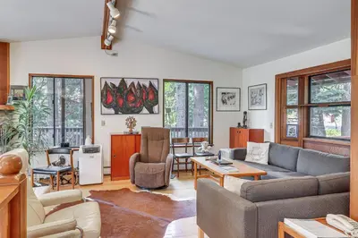 a living room with a couch and a table at 1 Mi to Beach Peaceful Tahoe Vista Home with Decks! in Tahoe Vista