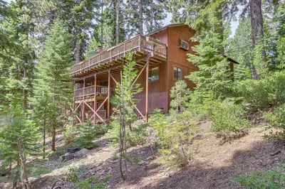 a wooden house in the middle of a forest at 1 Mi to Beach Peaceful Tahoe Vista Home with Decks! in Tahoe Vista