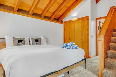 a bedroom with a white bed and wooden ceilings at Bright 3BR Condo Near Northstar in Truckee